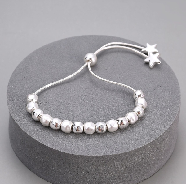 mixed-toned-balls-on-pullcord-bracelet-with-star-ends-silver
